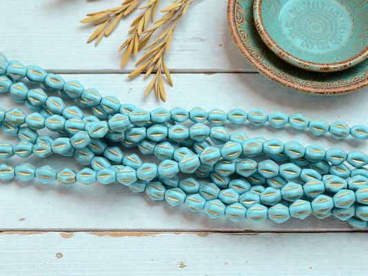 *26* 5x8mm Gold Washed Aero Blue Dented Oval Beads